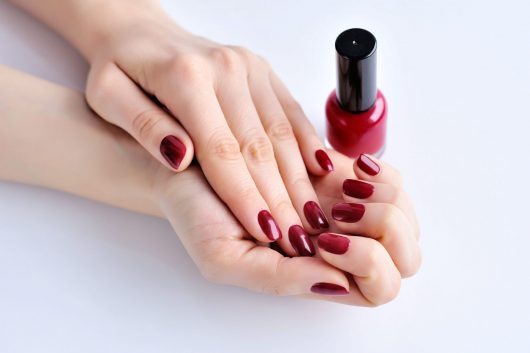hands-of-a-woman-with-dark-red-manicure-and-nail-P5VNS4S-onc99j5dfokzq2e5p4f5e1bp08x7p5nne5srkq7j2i